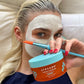 Elsa using our Halo Hydrator Scalp Mask while also using a skincare face mask for a little self-care