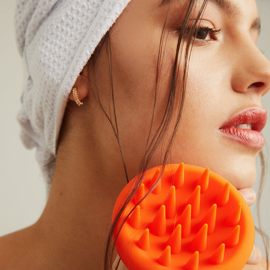 Model wearing the MicroFibre Head Towel and holding the Scalp Scrubber
